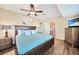 King-size bedroom with ceiling fan, wood furniture and access to the backyard at 18198 Burkholder Cir, Port Charlotte, FL 33948