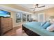 Relaxing main bedroom with king bed, window seating, and ceiling fan at 18198 Burkholder Cir, Port Charlotte, FL 33948