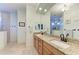 Double vanity bathroom with granite countertop and large mirror at 237 Albatross Rd, Rotonda West, FL 33947