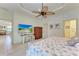 Bright bedroom with a king-size bed, built-in shelving, and large TV at 237 Albatross Rd, Rotonda West, FL 33947