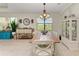 Bright dining room with a rustic wooden table and white chairs at 237 Albatross Rd, Rotonda West, FL 33947