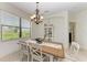 Charming dining room with wooden table and white chairs at 237 Albatross Rd, Rotonda West, FL 33947
