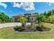 One-story home with teal door, paver driveway, and landscaped yard at 237 Albatross Rd, Rotonda West, FL 33947