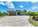 One-story home with teal door and paver driveway at 237 Albatross Rd, Rotonda West, FL 33947