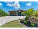 One story home with teal door and paver driveway at 237 Albatross Rd, Rotonda West, FL 33947