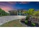 One-story home with teal door, paver driveway, and landscaped yard at 237 Albatross Rd, Rotonda West, FL 33947