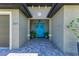Home's entrance with teal double doors and potted plants at 237 Albatross Rd, Rotonda West, FL 33947