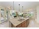 Kitchen with granite island, stainless steel appliances, and open concept floor plan at 237 Albatross Rd, Rotonda West, FL 33947