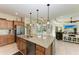 Open concept kitchen with granite island, stainless steel appliances, and views to living area at 237 Albatross Rd, Rotonda West, FL 33947