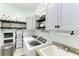 Bright laundry room with washer, dryer, and ample storage at 237 Albatross Rd, Rotonda West, FL 33947