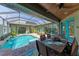 Inviting pool area with covered patio, dining table, and comfortable seating at 237 Albatross Rd, Rotonda West, FL 33947