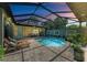 Enclosed pool area with patio furniture and dining table at 237 Albatross Rd, Rotonda West, FL 33947