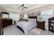 Spacious main bedroom with tray ceilings, neutral paint, shutters, and wood-look flooring at 25470 Palisade Rd, Punta Gorda, FL 33983