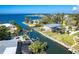Waterfront property featuring a private boat dock, swimming pool, and lush tropical landscaping at 275 North Dr, Englewood, FL 34223