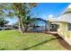 Backyard with a clear view of the pool in the screened-in patio and canal in the background at 275 North Dr, Englewood, FL 34223