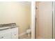 Bathroom featuring a shower, toilet, and vanity with a white cabinet and marble countertop at 275 North Dr, Englewood, FL 34223