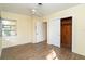 Bright bedroom featuring wood-look floors, a ceiling fan, and a closet with sliding doors at 275 North Dr, Englewood, FL 34223