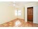 Bedroom featuring terracotta floors, a ceiling fan, and closet with sliding doors at 275 North Dr, Englewood, FL 34223