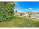 Manicured lawn, mature trees, and charming curb appeal enhance this home's exterior at 275 North Dr, Englewood, FL 34223