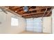 Spacious garage featuring an automatic door opener, painted walls, and open ceiling at 275 North Dr, Englewood, FL 34223