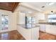 Modern kitchen featuring tile floors, white cabinets, stainless appliances, and marble countertops at 275 North Dr, Englewood, FL 34223