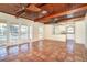 Spacious living room with terracotta tile, high wood ceilings, and doors to the backyard pool at 275 North Dr, Englewood, FL 34223