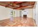 Spacious living room features unique tiled floors, beamed ceilings, and a fireplace at 275 North Dr, Englewood, FL 34223