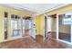 Living room with tiled floors, multiple entryways, and views to screened-in porch at 275 North Dr, Englewood, FL 34223