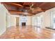 Spacious living room with terracotta tile, high wood ceilings, fireplace, and doors to the outside at 275 North Dr, Englewood, FL 34223