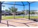 Screened-in patio with brick floor overlooking the canal and waterfront homes under a clear blue sky at 275 North Dr, Englewood, FL 34223