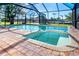 This backyard features a pool and hot tub combo, within a screened in enclosure at 275 North Dr, Englewood, FL 34223