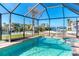 This screened-in pool and jacuzzi offer waterfront views and a private backyard at 275 North Dr, Englewood, FL 34223