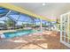 Screened-in pool area with brick floor and views of the waterfront at 275 North Dr, Englewood, FL 34223