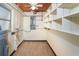 Wood-look floor in the storage area with built-in shelving, and an electrical panel at 275 North Dr, Englewood, FL 34223
