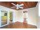 Sunroom with wood plank ceiling, a ceiling fan, and exterior access at 275 North Dr, Englewood, FL 34223