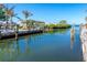 Serene view of the canal, reflecting waterfront homes and clear blue sky on a sunny day at 275 North Dr, Englewood, FL 34223