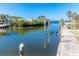 Beautiful view of the canal with docks, boat lifts, and waterfront homes under a clear blue sky at 275 North Dr, Englewood, FL 34223