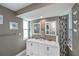 Double vanity, stylish tile, and updated features in this bright bathroom at 30 Oakland Hills Pl, Rotonda West, FL 33947