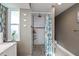 Clean bathroom with walk-in shower, tiled walls, and a window for light at 30 Oakland Hills Pl, Rotonda West, FL 33947