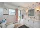 Bathroom with white subway tile, flamingo wallpaper, and a double vanity at 30 Oakland Hills Pl, Rotonda West, FL 33947