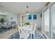 Bright dining area with white table and chairs, near sliding glass doors at 30 Oakland Hills Pl, Rotonda West, FL 33947