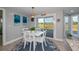 Casual dining area with white table and chairs and view of the backyard at 30 Oakland Hills Pl, Rotonda West, FL 33947