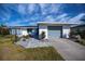 Updated single story home with gray garage door and landscaped yard at 30 Oakland Hills Pl, Rotonda West, FL 33947