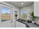 Modern kitchen features white cabinets, stainless steel sink, and a garden view at 30 Oakland Hills Pl, Rotonda West, FL 33947