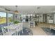 Open concept kitchen and dining area with white cabinets and granite countertops at 30 Oakland Hills Pl, Rotonda West, FL 33947