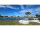 Peaceful lake view with benches and American flag at 30 Oakland Hills Pl, Rotonda West, FL 33947