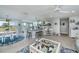 Bright living room with open floor plan, kitchen island, and view to backyard at 30 Oakland Hills Pl, Rotonda West, FL 33947