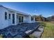 Outdoor patio with pavers, white furniture, and grassy area at 30 Oakland Hills Pl, Rotonda West, FL 33947