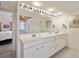 Double vanity bathroom with a large mirror and view to bedroom at 33 Seawatch Dr, Boca Grande, FL 33921