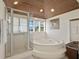 Bathroom with a large bathtub, shower and wood ceiling at 33 Seawatch Dr, Boca Grande, FL 33921